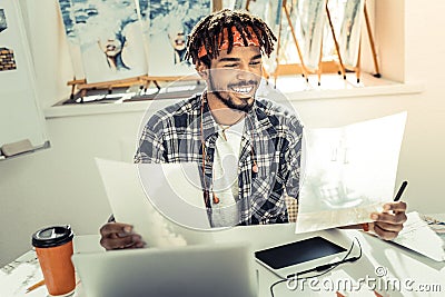 Young promising artist having much inspiration while working Stock Photo