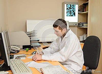 Young radiologist doctor analyses the digital x ray on the computer Stock Photo