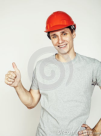 Young real hard worker man isolated on white background on ladder smiling posing, business concept Stock Photo