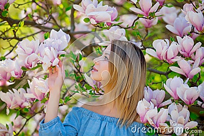 Girl in blossom magnolia garden. Stock Photo