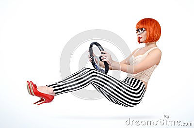 Young redhead girl driver car with steering wheel, auto concept Stock Photo