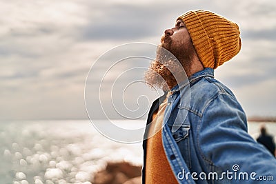 Young redhead man breathing at seaside Stock Photo