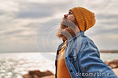 Young redhead man breathing at seaside Stock Photo