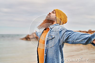 Young redhead man breathing at seaside Stock Photo