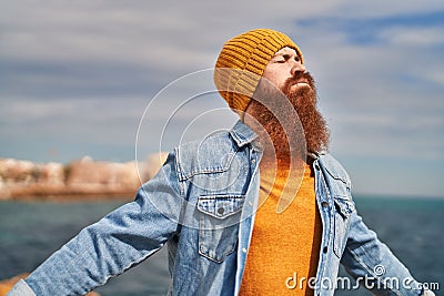 Young redhead man breathing at seaside Stock Photo