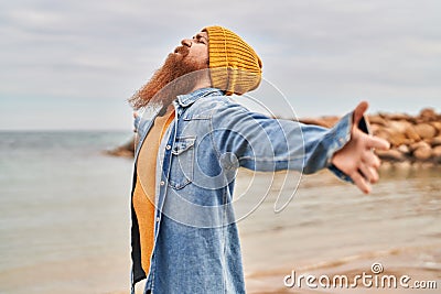 Young redhead man breathing at seaside Stock Photo