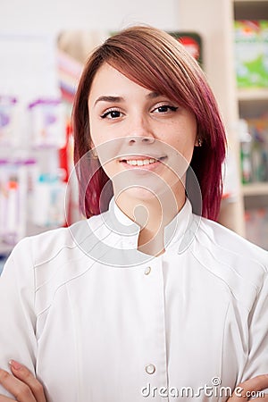 Young redhead pharmacist in front of her desk Stock Photo