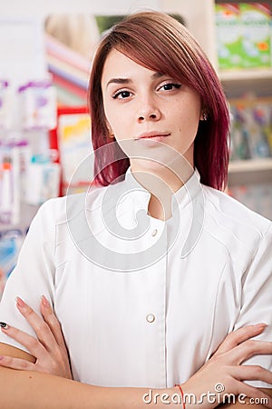 Young redhead pharmacist in front of her desk Stock Photo