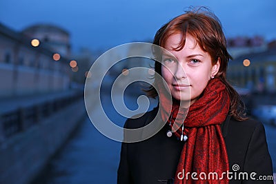 Young redhead woman at dusk Stock Photo