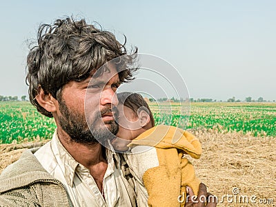 A young refugee child is sleeping on the shoulder of his father and both looks so tired hungry and terrified Stock Photo