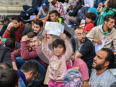 A young refugee girl holds up a SOS sign at Keleti Rail Station, Budapest in September 2015 Editorial Stock Photo