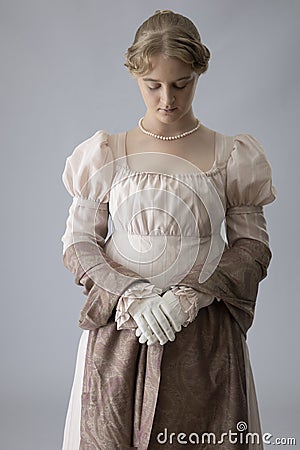 A young Regency woman in a pink dress and pearl necklace Stock Photo