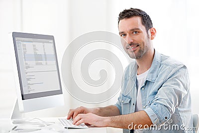 Young relaxed man using computer Stock Photo