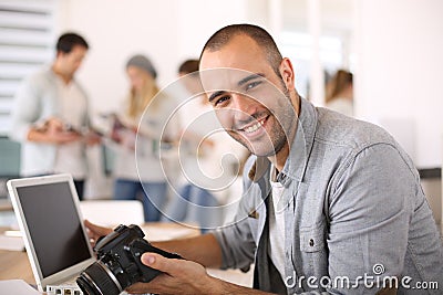 Young reporter working at office on laptop Stock Photo