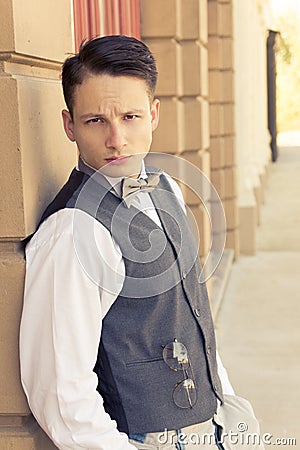 Young retro male model posing outdoors by the wall Stock Photo