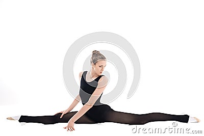 Young rhythmic gymnast in sportswear stretching and looking away Stock Photo