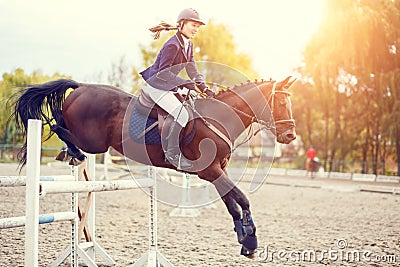 Young rider girl on horse show jumping competition Stock Photo