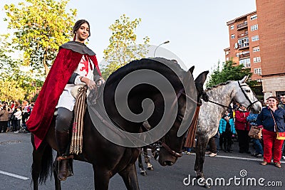 A young rider on her horse in medieval dress during the celebration of Saint George and the dragon. Editorial Stock Photo