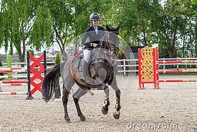 Young rider on horse show, jumping competition ,trained horse for Equitation sport competition Editorial Stock Photo