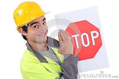 Road worker holding a stop sign. Stock Photo