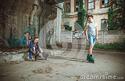 Young roller couple on graffiti background Stock Photo