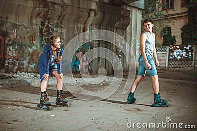 Young roller couple on graffiti background Stock Photo