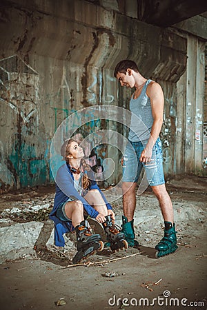 Young roller couple on graffiti background Stock Photo