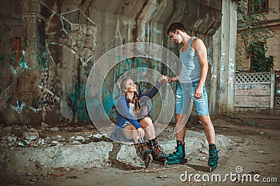 Young roller couple on graffiti background Stock Photo