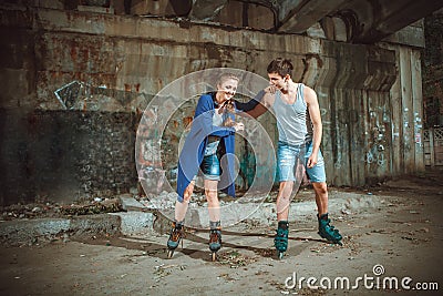 Young roller couple on graffiti background Stock Photo