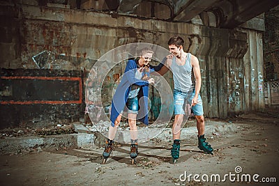 Young roller couple on graffiti background Stock Photo