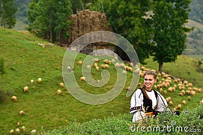 Young Romanian girl smiling, old shepherd house in the background Editorial Stock Photo