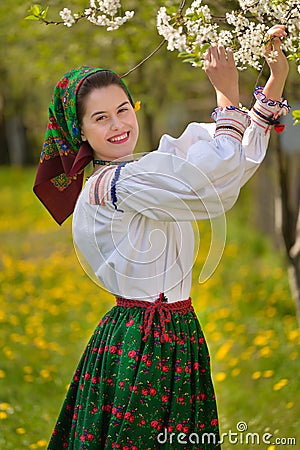 Young Romanian girl smiling in the spring time with traditional costume Editorial Stock Photo