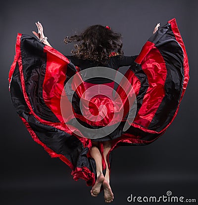 Young romany woman fly in spanish traditional clothes Stock Photo