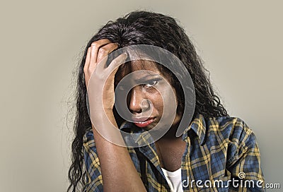 Young sad and depressed black African American woman anxious and overwhelmed feeling sick and stressed on studio backgrou Stock Photo