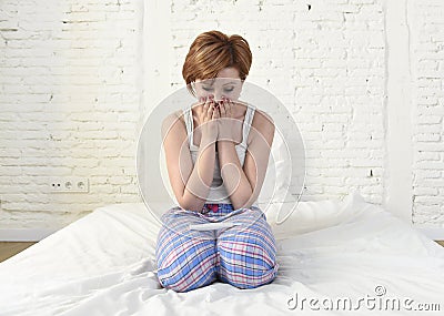 Young sad woman crying frustrated after checking negative or positive pregnancy test Stock Photo