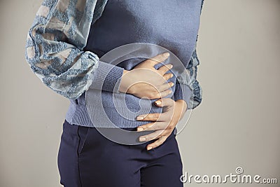 Young woman hand in ache stomache Stock Photo