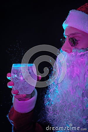 Young Santa Claus drinking tonic water Stock Photo