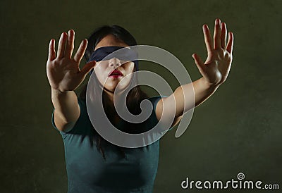 Young scared and blindfolded Asian Chinese teenager girl lost and confused playing dangerous internet viral challenge on Stock Photo