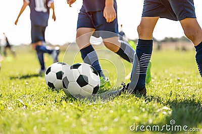 Young School Footballers Dribbling Around Cones in Drill on a Sunny Day Stock Photo