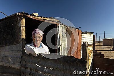 A young school girl alone in a squatter camp Editorial Stock Photo