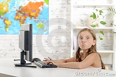 Young school girl grimaces in the classroom Stock Photo