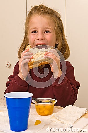 Young school girl eating lunch Stock Photo