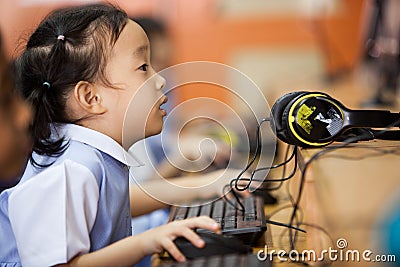 Young school kids start learning how to use a computer. Editorial Stock Photo