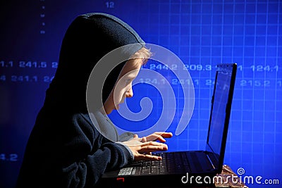 Young schoolboy prodigy - a hacker. Hacker at work. Stock Photo