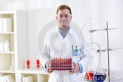 Young science holding tubes at professional lab Stock Photo