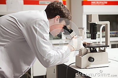 Young science student looking in a microscope Stock Photo