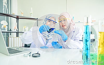 Young science students doing an experiment in a laboratory Stock Photo