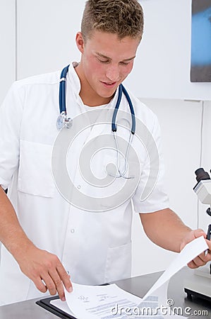 Young scientist looking at data sheet results Stock Photo