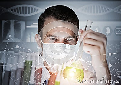 Young scientist mixing reagents in glass flask in clinical laboratory Stock Photo