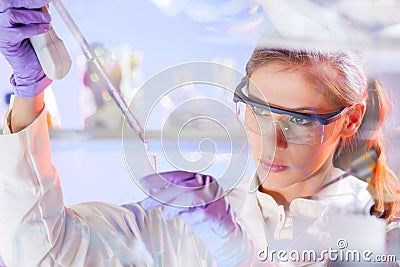 Young scientist pipetting in life science laboratory. Stock Photo